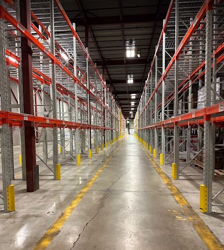 Warehouse aisle with tall racks and boxes